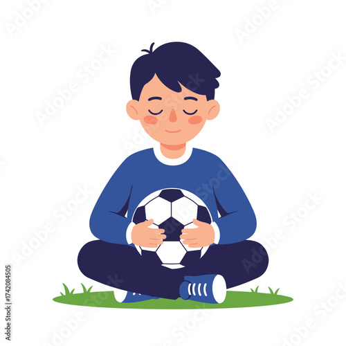 A peaceful young boy sits cross-legged on the grass, gently holding a soccer ball with his eyes closed, embodying calm reflection.