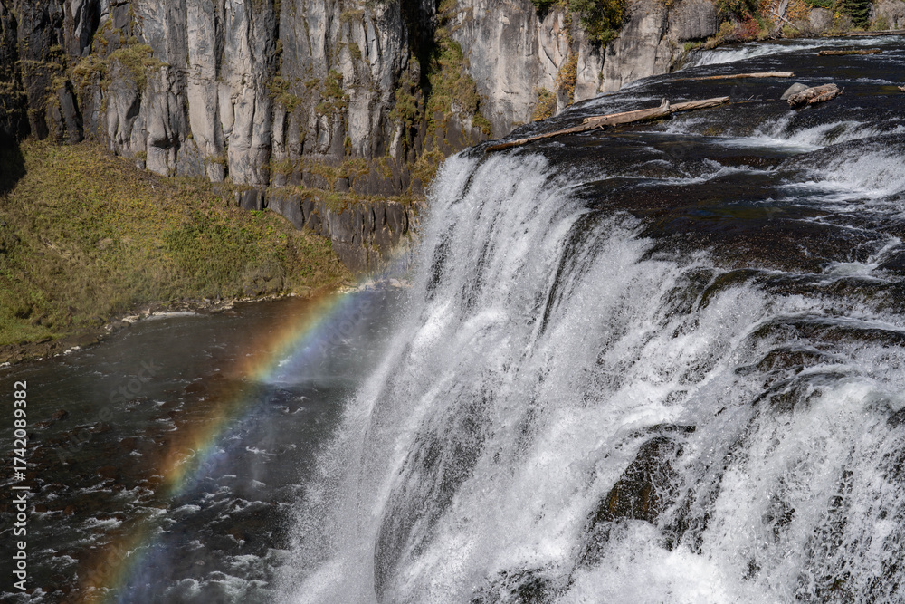Fototapeta premium Rainbow. Upper Mesa Falls is a waterfall on the Henrys Fork in the Caribou-Targhee National Forest. Fremont County, Idaho. Henrys Fork (Snake River tributary). Basalt 