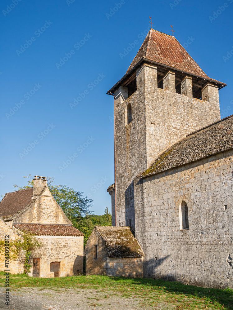 Fototapeta premium Scenic vertical view of old stone church in historic Saint Avit medieval village, Lot-et-Garonne, France