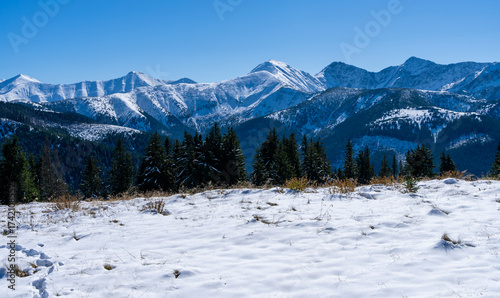 Panorama of mountain ridges in the first autumn snow.