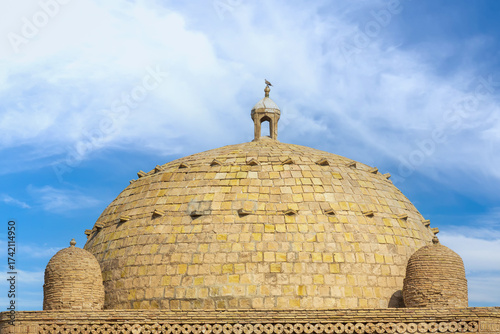 Dome from baked brick of Samanid Mausoleum against blue sky background in Bukhara, Uzbekistan. Built in the 10th century CE