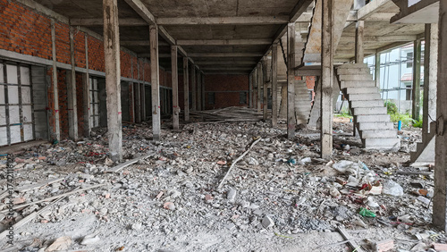 Ground level view of building under construction with partial red brick layout