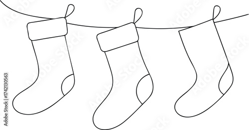 Three Christmas stockings hanging on a string holiday