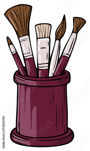 Art supplies collection including paintbrushes in a burgundy colored cup for artists and painters