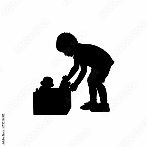 Silhouette of a child helping to put toys into a box isolated on white background