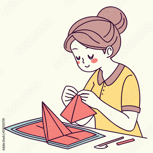 Woman making origami with paper on a table