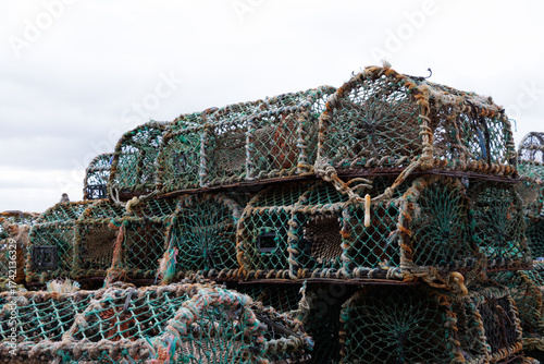 Stack of old rusty Scottish lobster pots on a quay in Fife, Scotland