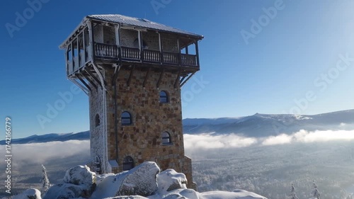 view of Szklarska Poreba in clouds and Krkonose mountains. snow on a High Stone and winter landscape under bright sun. Poland