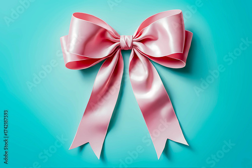 A beautifully tied, vibrant satin bow with long tails on a bright, solid blue background. Luxurious packaging and holiday gift concept.
