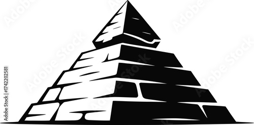 Ancient egyptian pyramid constructed from rough stone blocks in a stark black silhouette