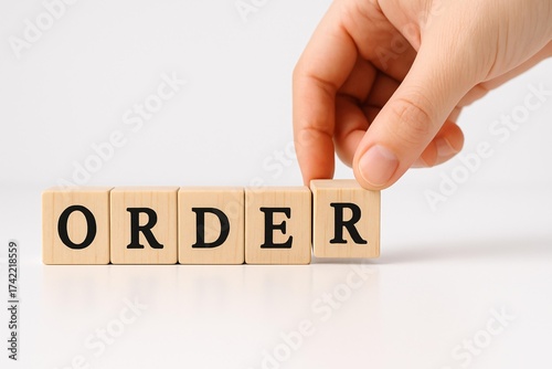 Managing Business Orders: Conceptual Image of Hand Arranging Wooden Blocks