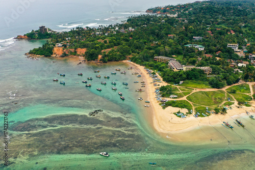 Weligama Beach drone photography—Sri Lankan fishing boats, palm-lined coast, and scenic Indian Ocean shoreline