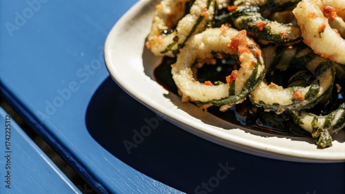 Crispy zucchini fritters served on a white plate