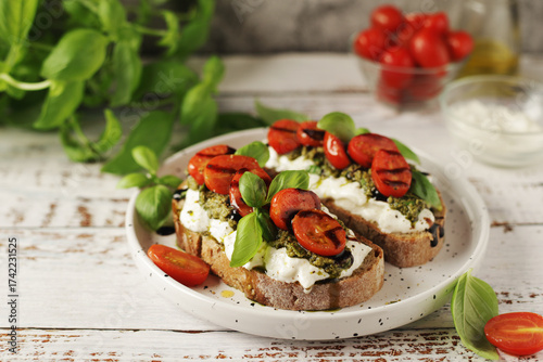 Italian sandwiches with grilled tomatoes, burrata cheese and pesto	