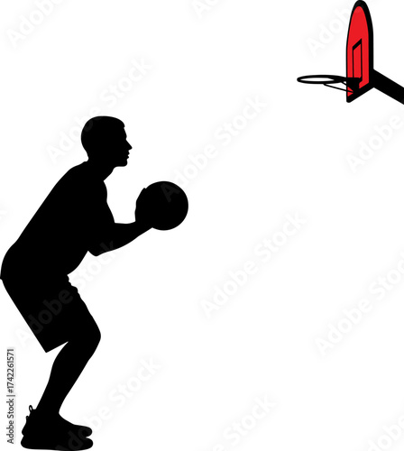Silhouette of a basketball player preparing to shoot at a hoop