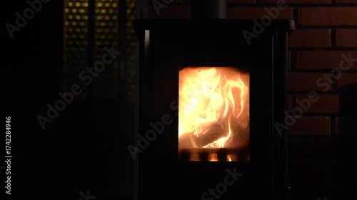 Oven with glass window and fire inside.