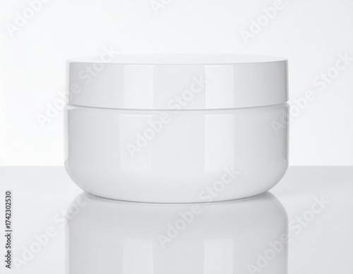 A clean white cosmetic jar with a lid, isolated on a reflective white surface in a studio setting, perfect for beauty product packaging mockups