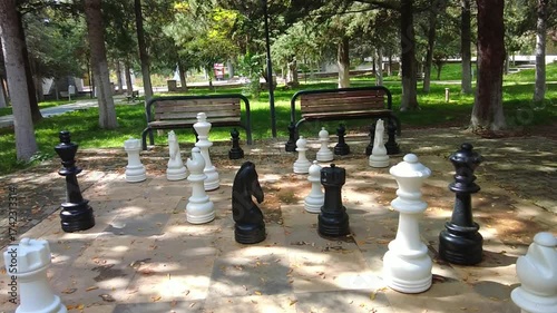 A chessboard with pieces in the city park is ready for matches all year round.