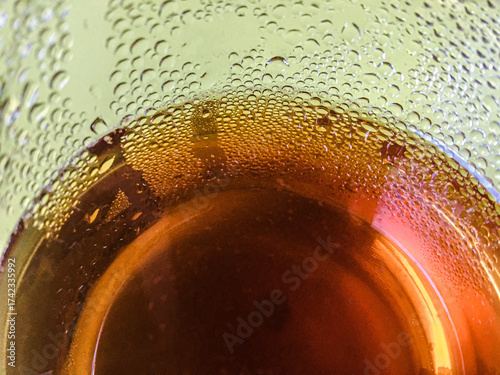 Cold peach iced tea seen from inside the glass