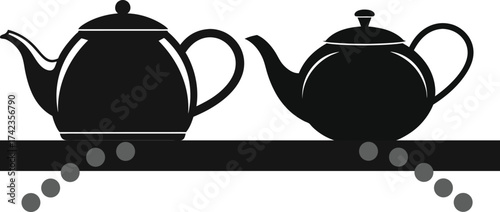 Two black teapots with decorative dots