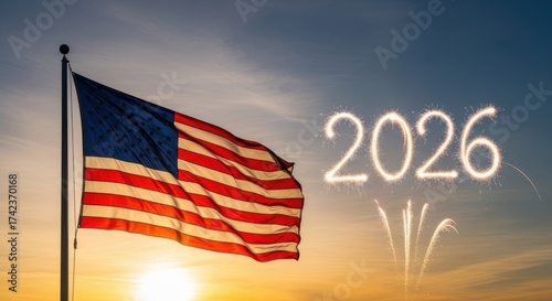American flag waving in the wind with 2026 written in sparklers at sunset