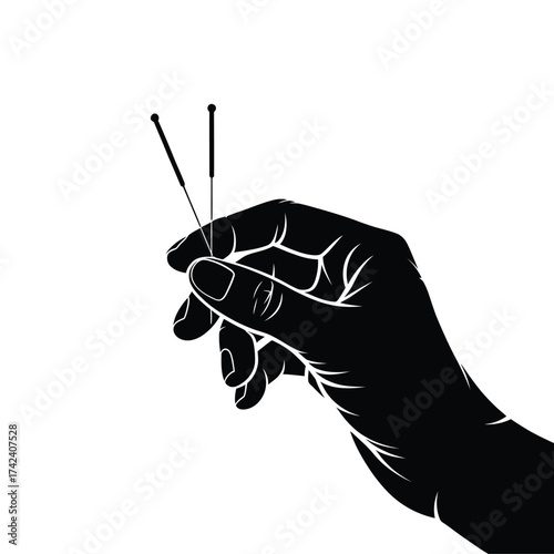 Acupuncture needles held in a hand for treatment