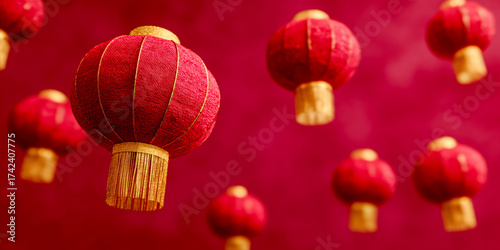 Multiple red Chinese lanterns with gold accents are suspended against a matching red background. The lanterns are arranged in a festive and decorative manner, creating a vibrant.