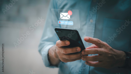 Businessman touching new message notification icon on virtual screen,email alert, online messaging system, representing digital communication, instant response, and business connectivity.