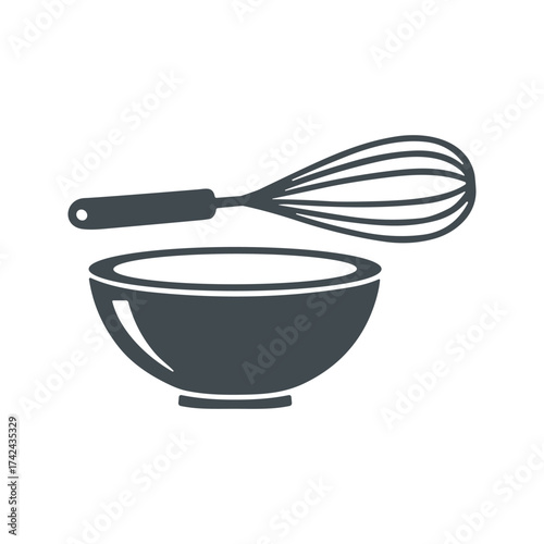 A simple mixing bowl sits next to a whisk, showing the basic equipment used for cooking and baking desserts or meals in the kitchen.