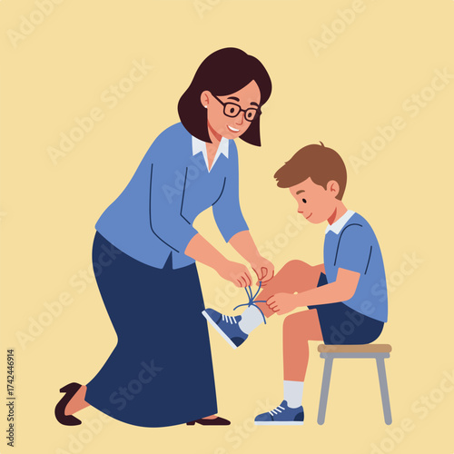 A woman helps a young boy tie his shoe laces while he sits on a stool