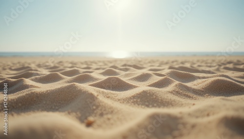 Fototapeta Naklejka Na Ścianę i Meble -  sunlit textured sand dunes on a tranquil beach with soft distant sea horizon