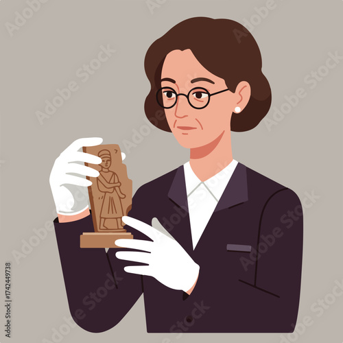 Woman in glasses and suit holding artifact with white gloves
