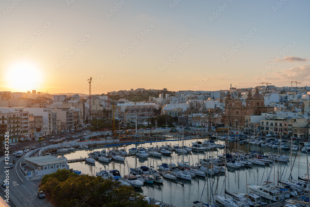 Obraz premium Sunset Over Marina with Yachts and Historic Church Skyline