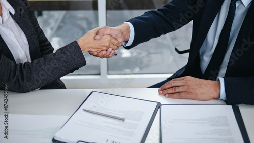 Lawyer consultant shaking hand with client sign contract agreement document in law firm. Business meeting Handshake