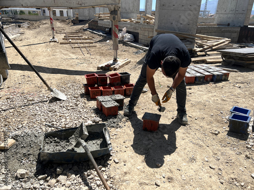 Engineers conducting slump tests for concrete strength.