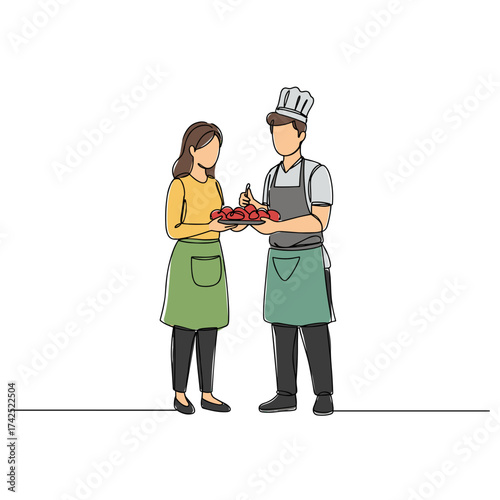 Couple in aprons presenting finished dish