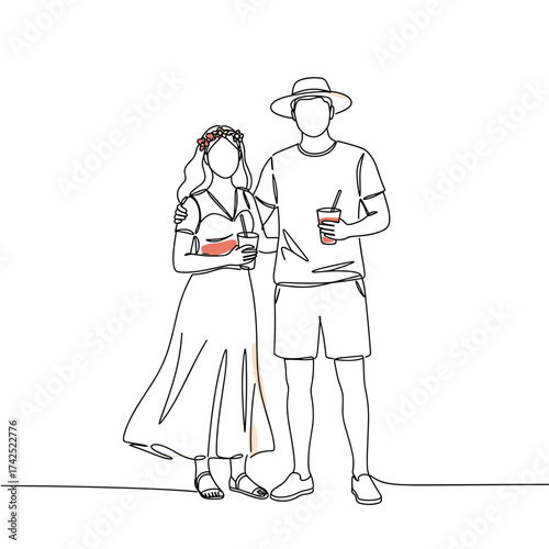 Young couple holding drinks during summer festival celebration  