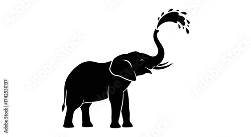 Silhouette of an Elephant with Raised Trunk and Water Splash.