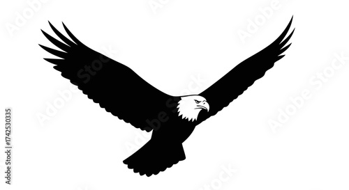 Majestic bald eagle soaring with outstretched wings against a white backdrop.