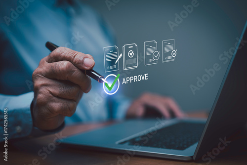 Fotografi Businessman using digital pen approving online documents on laptop with virtual check mark icon