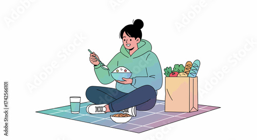 Young Woman Enjoying A Meal On A Picnic Blanket Outdoors