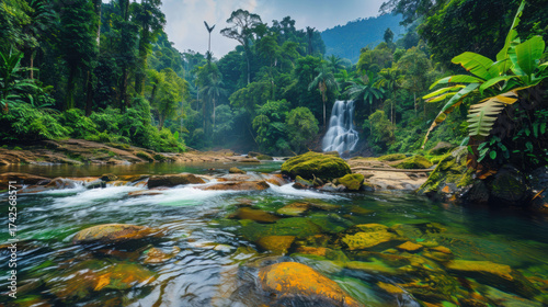 A breathtaking tropical river and waterfall surrounded by lush rainforest in Malaysia, crystal clear water, cinematic landscape