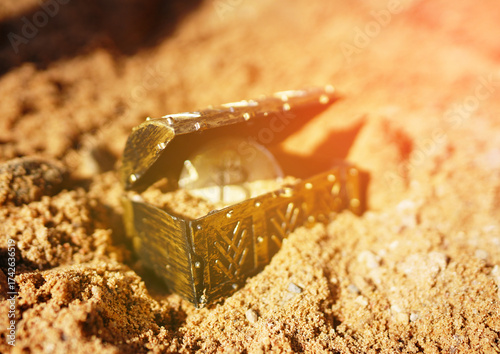 Bitcoin Treasure Chest. Treasure chest gold coin shiny Bitcoin buried in sand. BTC Crypto mining investing. Cryptocurrency as treasure. Treasure box with Bitcoin gold coin money. Hide money.