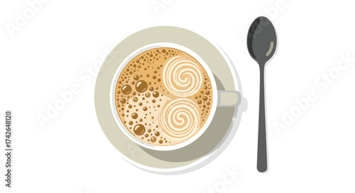 A top view of a frothy cappuccino with latte art and a spoon.