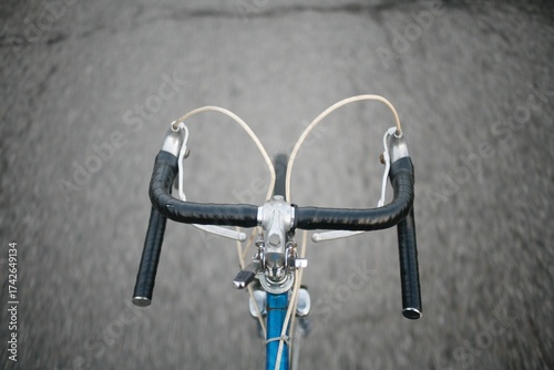 Point of view riding a vintage 10 speen bike on a city road 