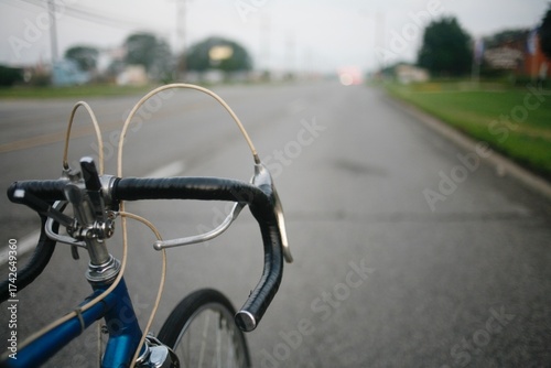 Point of view riding a vintage 10 speen bike on a city road 