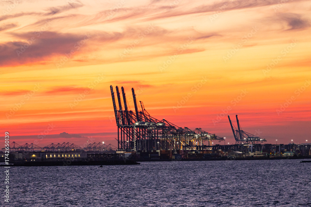 Fototapeta premium Container terminal with cranes in Hudson Bay at sunset.