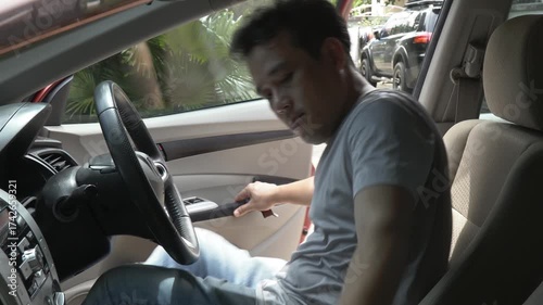 Masked thief reaching into car window trying to steal briefcase from frightened driver. Concept of car robbery, theft, danger, urban crime, and personal security awareness in real life situations