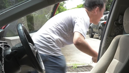 Thief and driver struggling over briefcase during car robbery in daylight, showing danger, crime, and violence. Concept of car theft, street crime, personal safety, and self-protection awareness