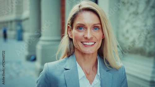 Smiling Businesswoman Standing Outdoors in Modern City Street